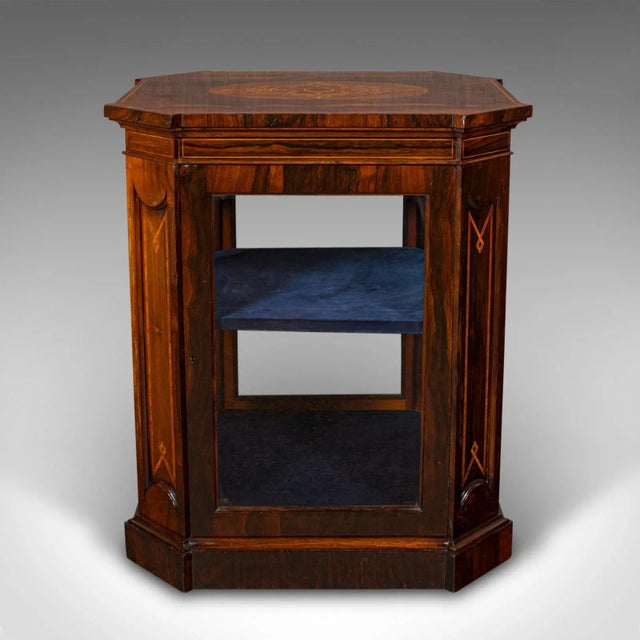 This is an antique jeweller's display cabinet. An English, rosewood and glass shop retail case, dating to the Regency...