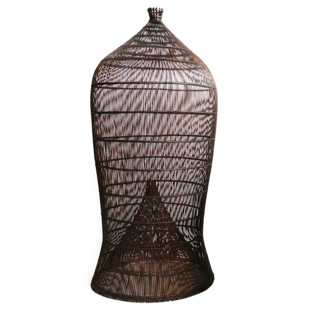 Auburn stained natural wicker lantern. Classic original fish trap basket shape. An interesting solution lighting fixture...