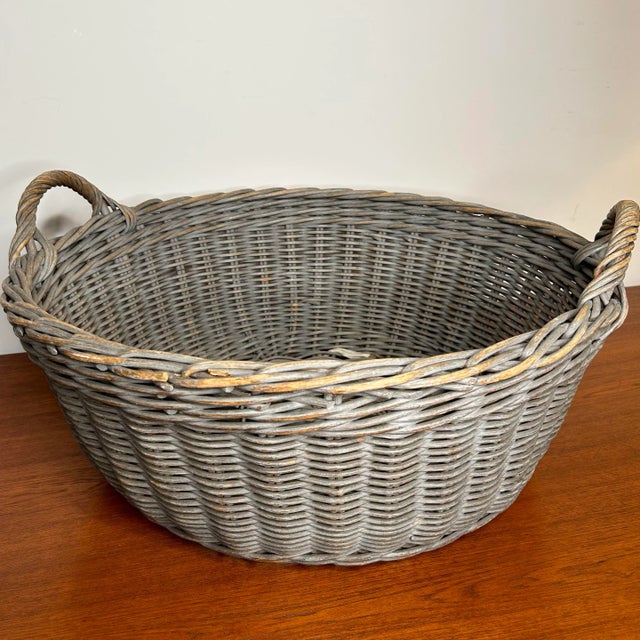 Large vintage wicker basket with gorgeous color and patina. Cloth ring for hanging. Height not including the handles is...