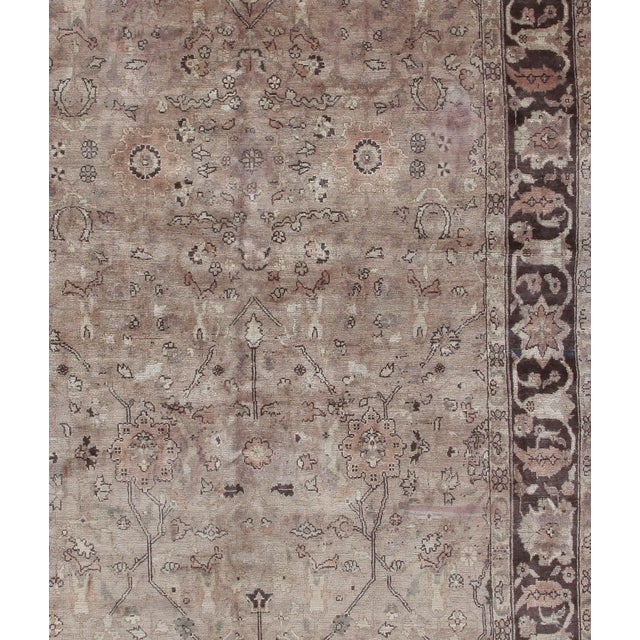 A hand knotted circa 1930's Sivas rug in shades of taupe and brown.