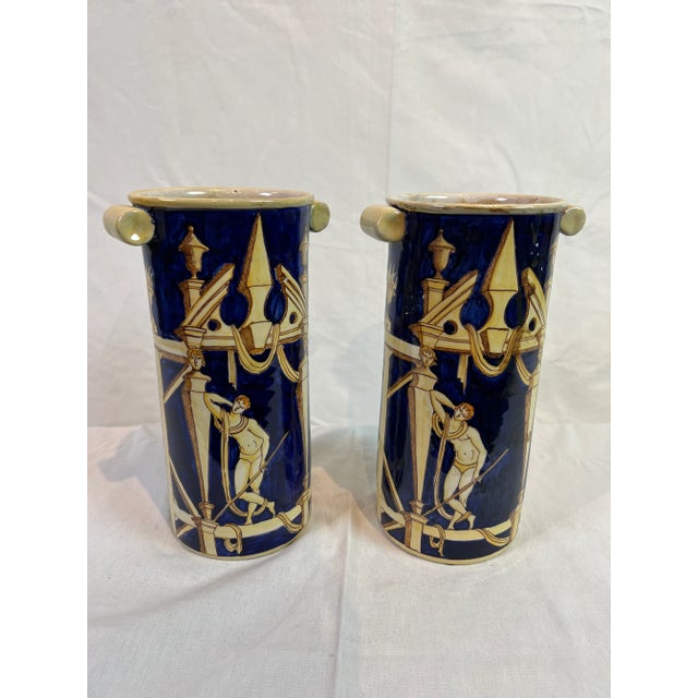 Classical Italian cylinder style vase featuring a grecian design with colors of cobalt and cream. Hand made and hand...