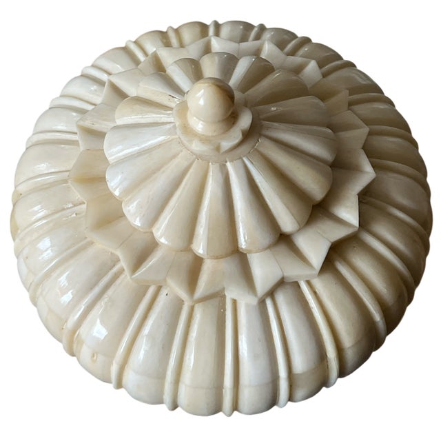 Sculptural carved bone snuff box with a domed, ribbed body and stepped lid topped by a turned finial. The form recalls...