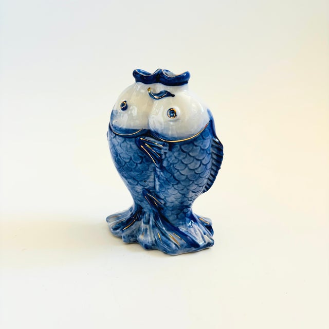 A vintage porcelain kissing koi fish vase. Double fish design with two separate mouth openings for displaying flowers....