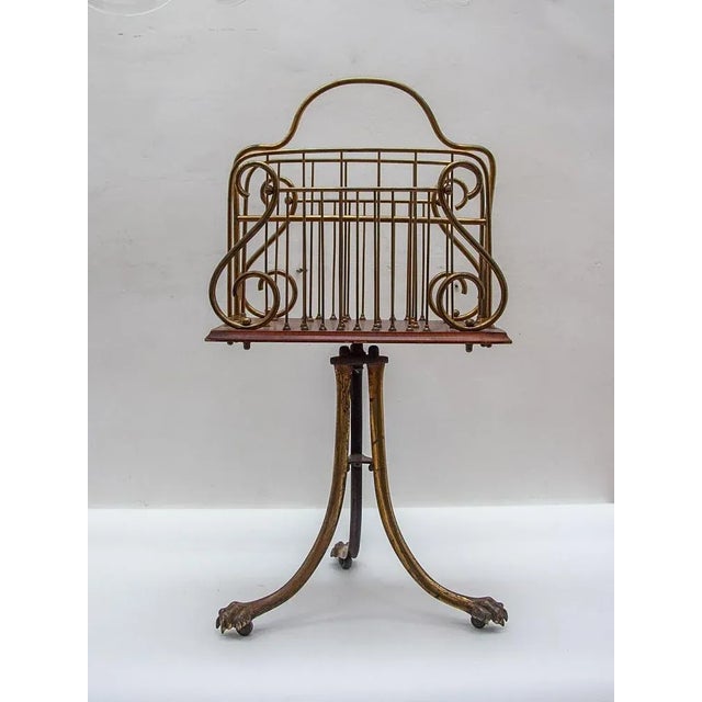 Quality antique victorian brass and mahogany revolving magazine stand having a shaped brass handle to the centre, four...