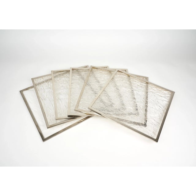 Set of six squared placemats in ice-effect acrylic and steel borders. Made in Italy 1970s.