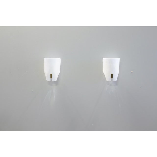 Pair of wall lamps, Model No. 167 px, 1952. Opal methacrylate diffuser with lacquered metal support. Made in Italy by...