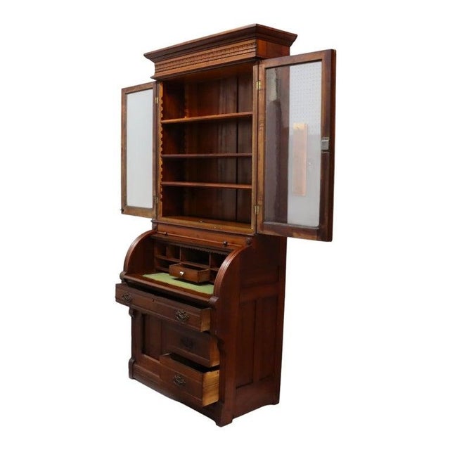 This antique Victorian secretary desk, crafted around 1880, features a sophisticated design in walnut and burl wood. The...