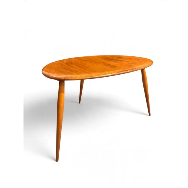A beautifully sculptural set of Ercol Pebble tables, showcasing the timeless elegance and craftsmanship synonymous with...