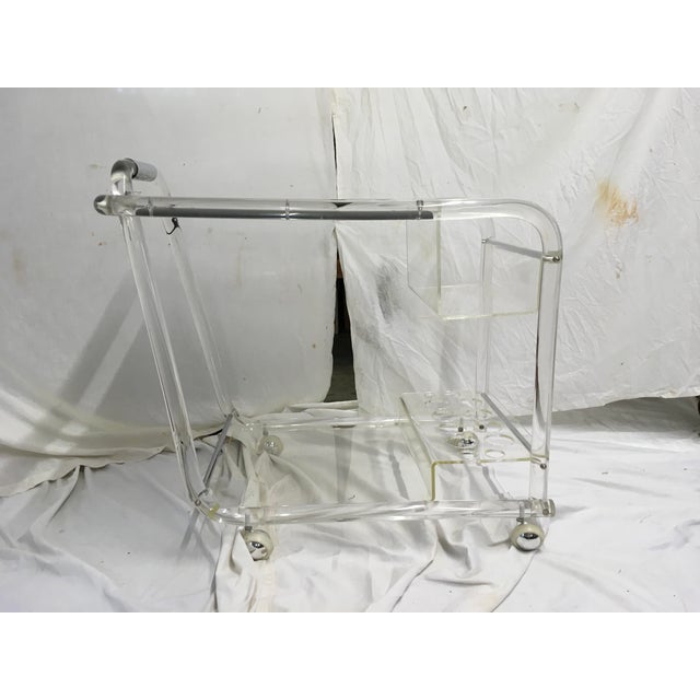 Unusual acrylic bar cart w/ chrome trim. New mirrored top, with top spirits caddy and bottom bar ware caddy. In very good...