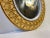 A decorative circular wall mirror in ochre yellow glazed ceramic. It was made in Italy during the 1970s, probably by...