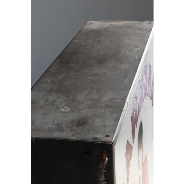 Vintage advertising lightbox from the 1970s, likely originating from a bar or similar venue. The piece features a metal...