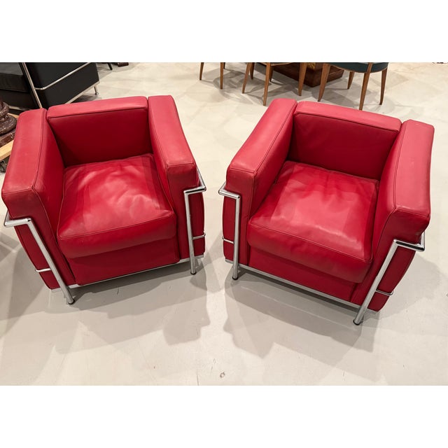 Beautiful and stylish chrome and red leather club chairs in the style of Le Corbusier.
