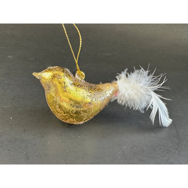 This art glass bird ornament is a sophisticated Christmas decoration for your holiday tree. The glass bird has gold foil...