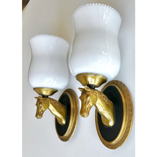 Pair of dimunitive mid-20th-century French Neoclassical wall sconces designed by the esteemed Parisian luxury house,...