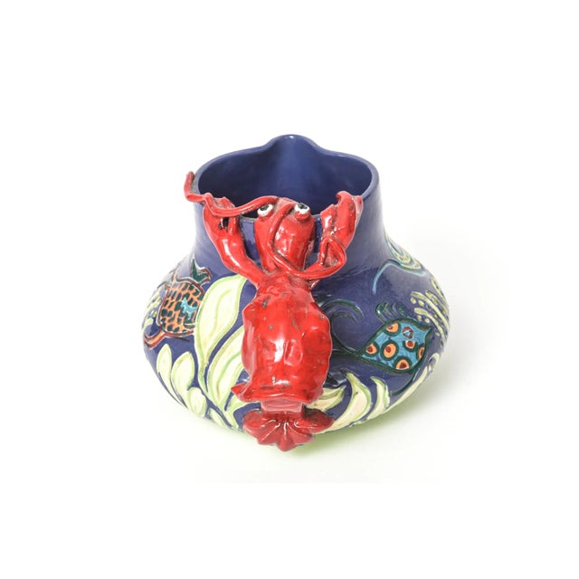 Unique handmade folk art pottery featuring a sealife design with fish swimming though a flowing underwater forest. The...
