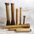 Collection of eight vintage wooden textile mill bobbins, quills, and spindles in a range of traditional industrial forms...