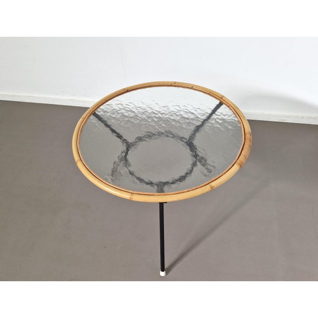 All original, from the steel base and white feet to the rattan rim and cloudy glass top. Made by Dutch company Rohé...