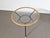 All original, from the steel base and white feet to the rattan rim and cloudy glass top. Made by Dutch company Rohé...