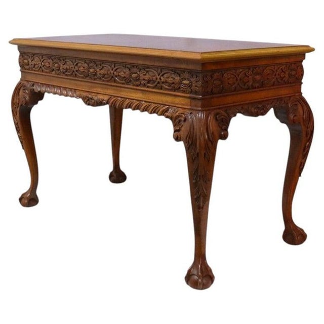 This antique Chippendale style table, dating to approximately 1900, is crafted from mahogany and features intricate floral...