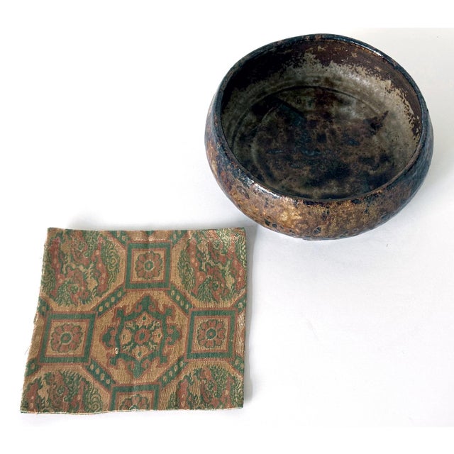 A stoneware round bowl with dramatic glaze made by Kitaoji Rosanjin (1883-1959) circa first half of the 20th century. The...