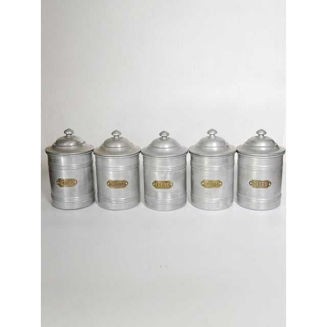 Set of six French provincial-style aluminum kitchen tins, France, 1950s. Charming set of six stamped aluminum storage...