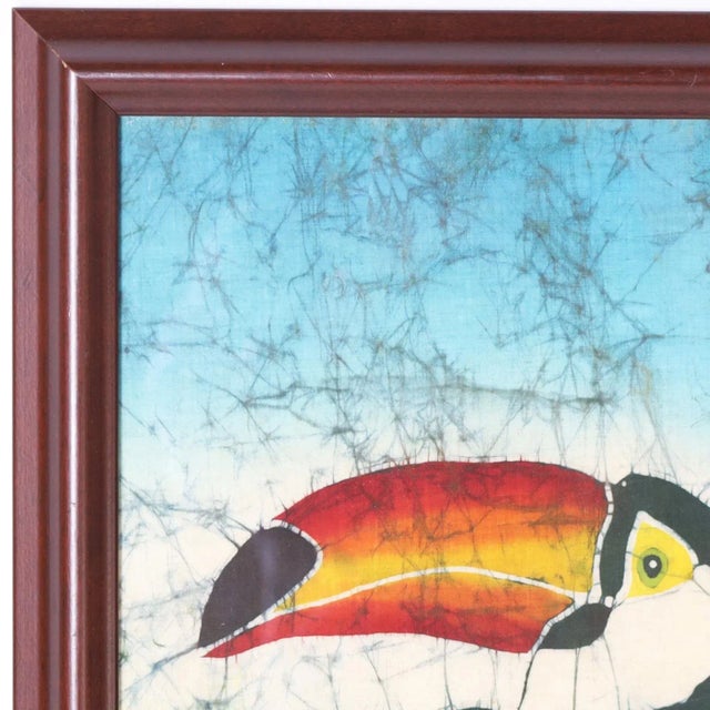 Transporting artwork of a toucan in a tree expertly executed in a batik dying technique on silk and indistinctly signed....