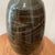 The product is a vintage stoneware vase in a unique horizontal rib bottle shape, stamped and signed by the handcrafted...