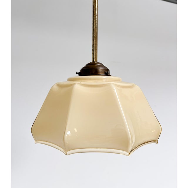 Charming Art Deco glass lamp in a soft beige shade. The colored glass creates a warm and diffused light. The curved and...