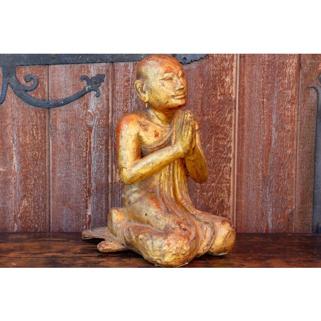 This beautiful Burmese monk statue is sitting in praying pose with a serene and calm expression. This figurine has a...