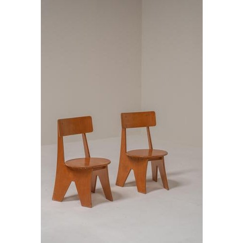 Pair of sculptural fireside chairs in layered plywood, most likely produced in Germany between 1970 and 1980. The design...