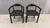 A stylish pair of Postmodern armchairs featuring sculptural black molded plastic construction with integrated armrests....