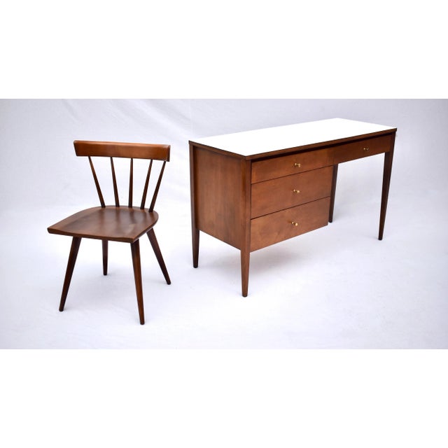 A striking Paul McCobb four drawer desk and matching chair with white laminate top. 1950's all original from the Planner...