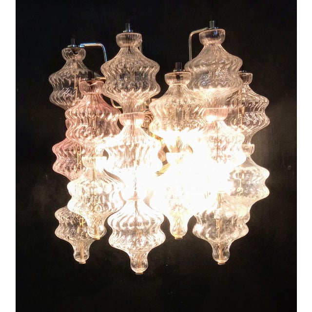 Murano glass wall light blown in a fixed mold with baloton finish. Transparent and amethyst color. Restored metal...