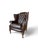 Chesterfield, Wingback Armchair in brown leather with deep-button tufting, they feature rolled arms, brass nailhead trim....