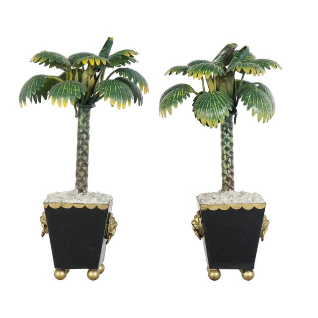 Bring a bold dose of Palm Beach glamour to your space with this striking pair of Italian Hollywood Regency tole palm tree...