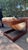 Thick walnut side frames with rounded corners. Cantilever/sled base shape. Exposed dowels or plug details. Stamp for...