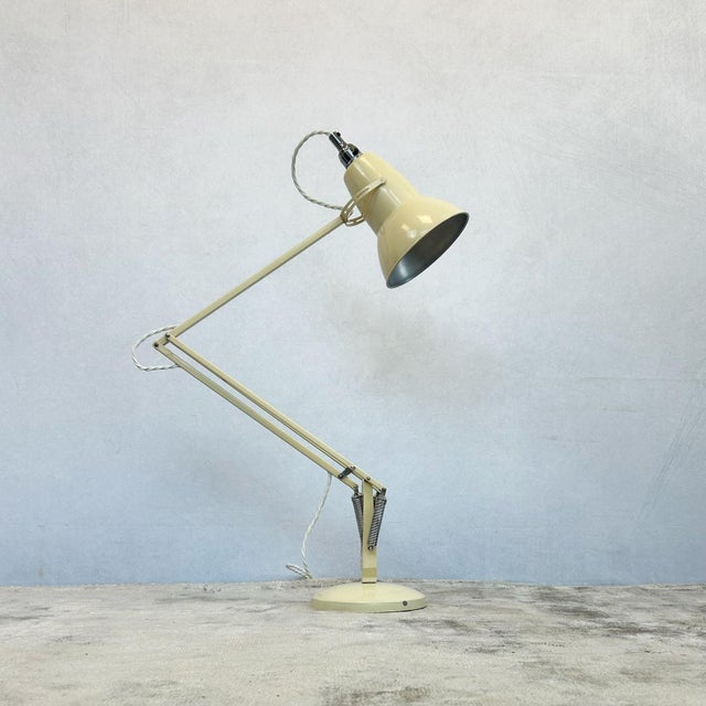 Anglepoise desk lamp in cream, designed by George Carwardine in 1934. Features characteristic conical shade with rolled...