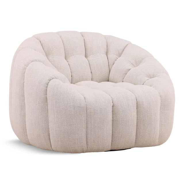 Tufted boucle upholstered plush swivel accent chair in a fresh ivory color. Modern rounded design with sloped arms for...
