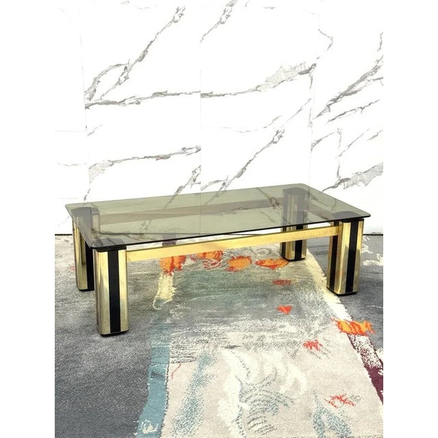 Wonderful coffee table made of gilt metal and plastic material, ochre glass top, produced in 1970s, Italian manufacture....