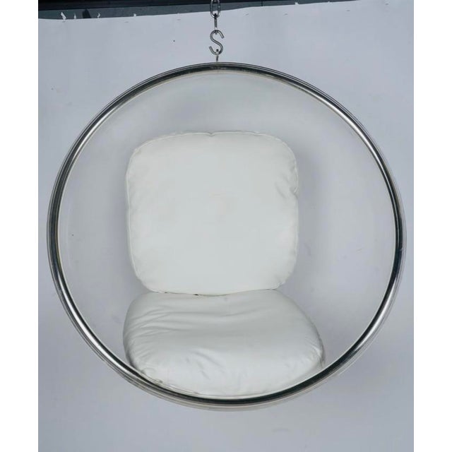 A swinging Space Age cocoon in crystal-clear acrylic, polished metal, and white upholstery—equal parts furniture,...
