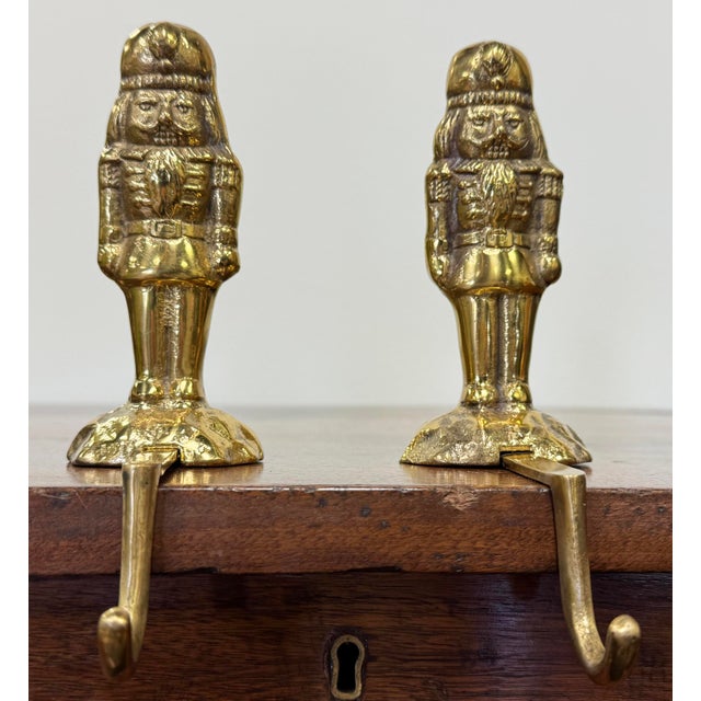 Vintage pair of brass nutcracker stocking hooks. Whimsical and classic with great detail. Patina.