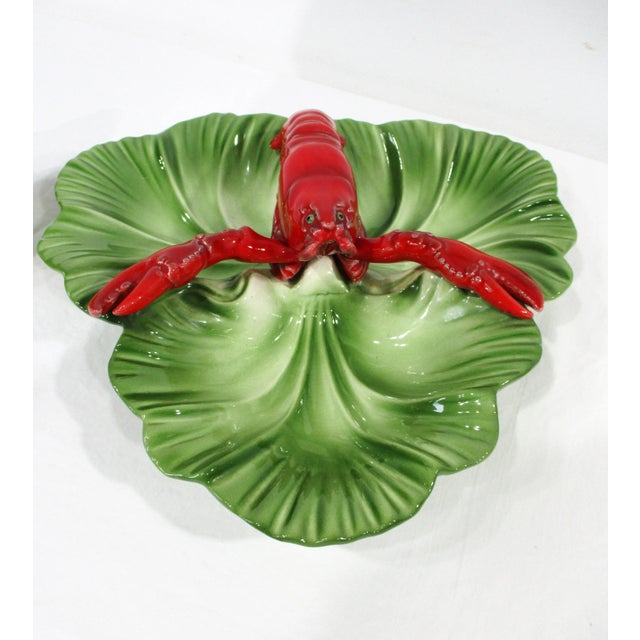 A set of two California pottery sauce bowls with lobster motif one having three divided areas and the other a lid , bowl...