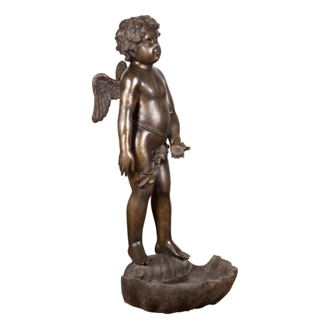 Lost Wax Bronze Statue of a Winged Cherub Standing on a Shell in Dark Patina For Sale