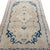 This understated antique rug is defined by its simplicity and graceful proportions. A small ivory geometric medallion sits...