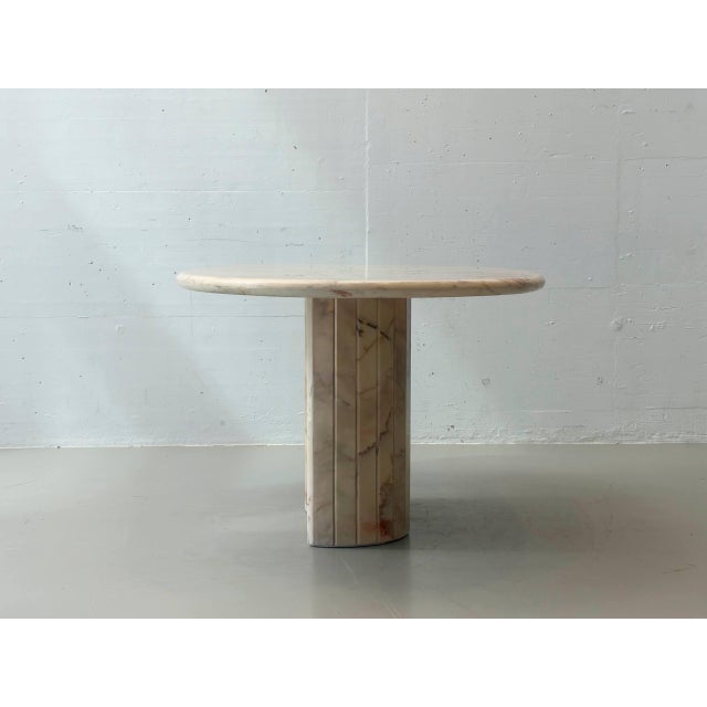 This exceptional dining table impresses with its sculptural form and high-quality craftsmanship in solid natural stone....