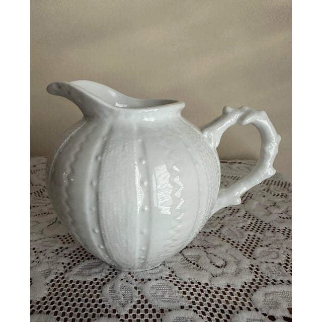 Beautiful white porcelain creamer dish or small pitcher by Paris Royal. Sea urchin pattern with coral patterned handle....