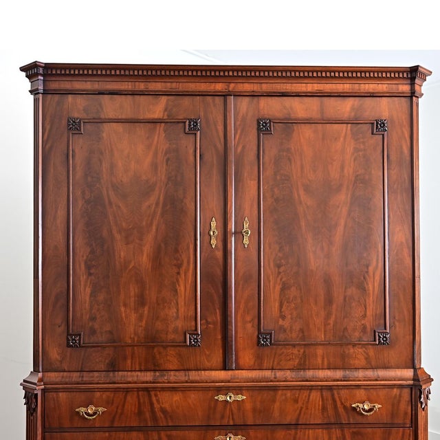 This massive Louis XVI style Dutch mahogany armoire from the late 1700s will make an architectural statement in any room....