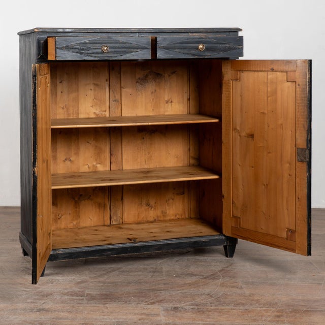 Late 19th century Swedish sideboard crafted in pine. The cabinet features a newer professionally applied black painted...