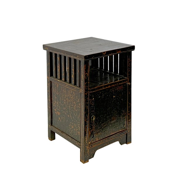 This is an end table nightstand with an oriental accent open shelf and crackle distressed mark black color. Dimensions:...