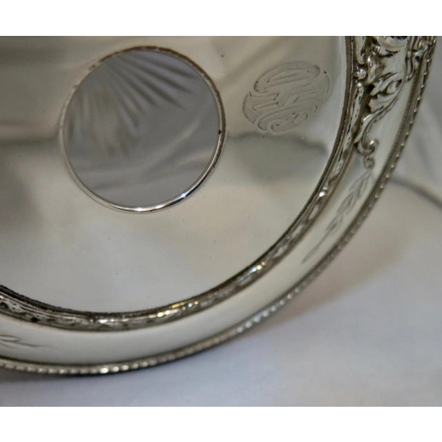 This vintage early 20th century pair of vanity jars are designed with banded etched crystal bowls accented with decorated...